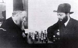 The 6th Lubavitcher Rebbe, left, playing chess with his younger son-in-law, the future 7th Rebbe, right, allegedly on Nittel Nacht.